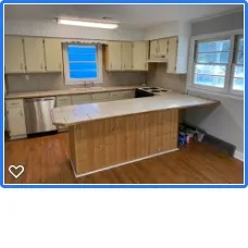 a view of kitchen with kitchen island a sink wooden floor and black appliances