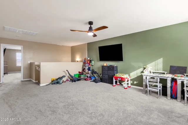 a bedroom with a large bed and a ceiling fan