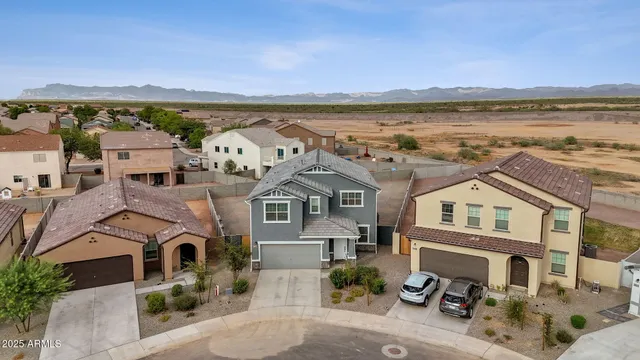 an aerial view of a city with ocean view in back