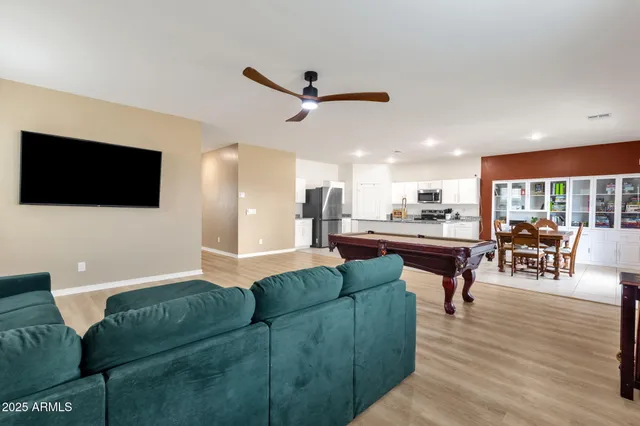 a room with furniture pool table and windows