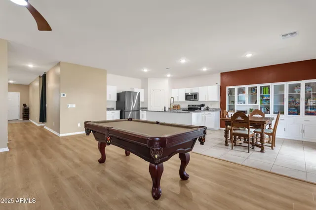 a kitchen with microwave a dining table and chairs