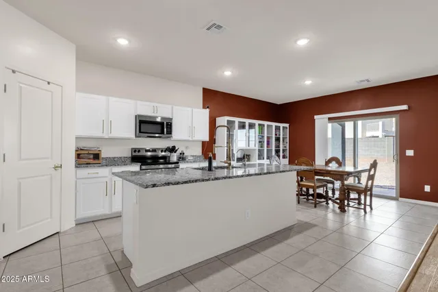 a kitchen with a refrigerator a microwave a stove and a sink