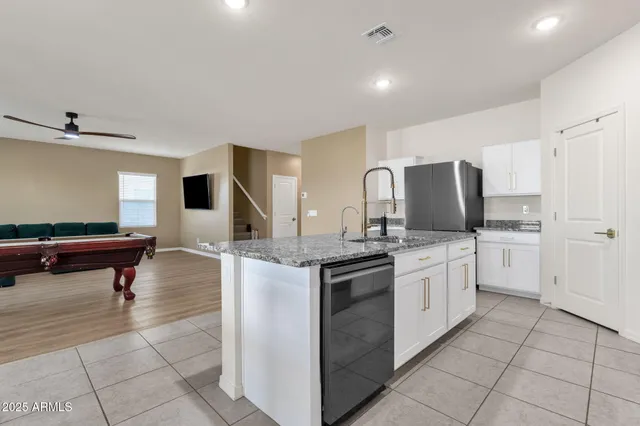 a kitchen with stainless steel appliances granite countertop a sink and cabinets