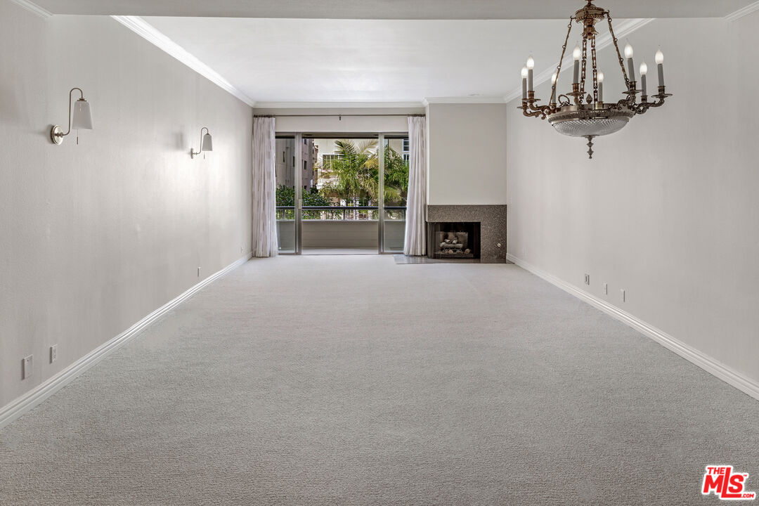 11808 Dorothy Street, Unit 206 Los Angeles, CA 90049 - Photo 12 of 33 a view of a livingroom with an empty space and a fireplace