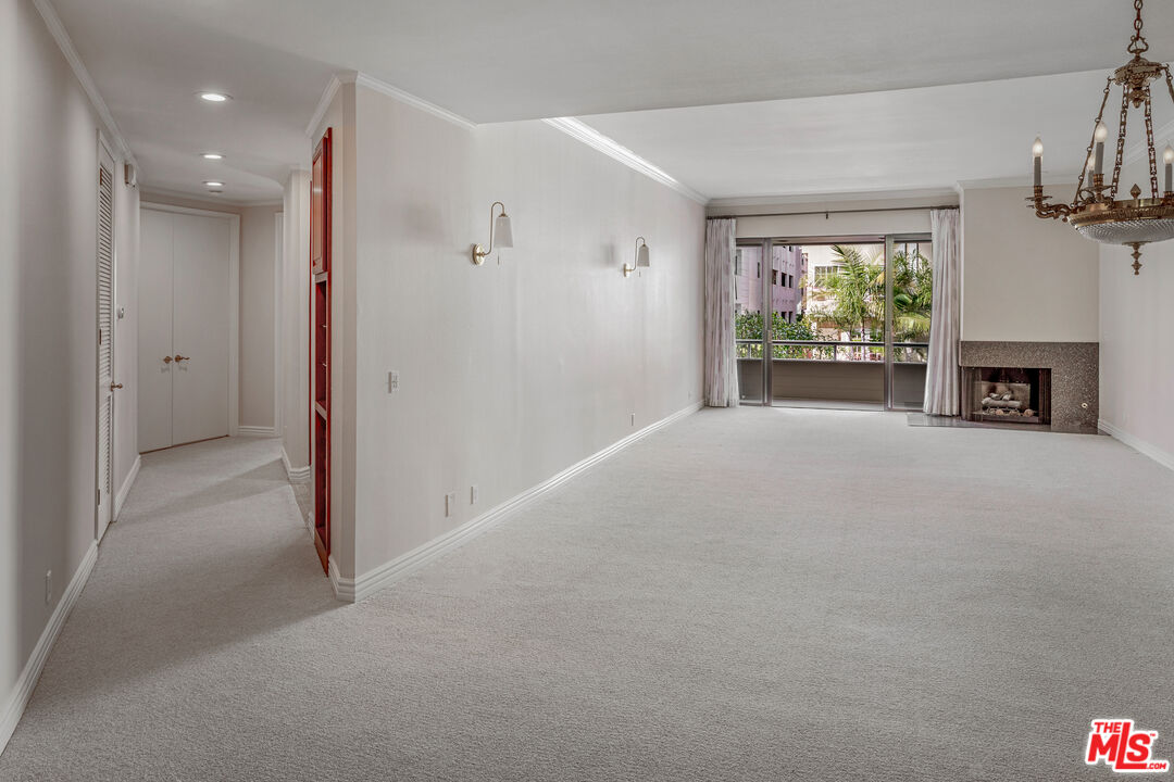 11808 Dorothy Street, Unit 206 Los Angeles, CA 90049 - Photo 13 of 33 a view of a livingroom with an empty space and a fireplace