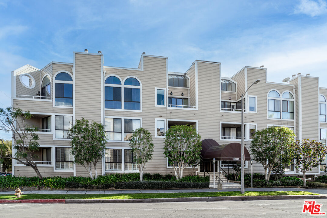 11808 Dorothy Street, Unit 206 Los Angeles, CA 90049 - Photo 2 of 33 a view of a building with a garden and trees