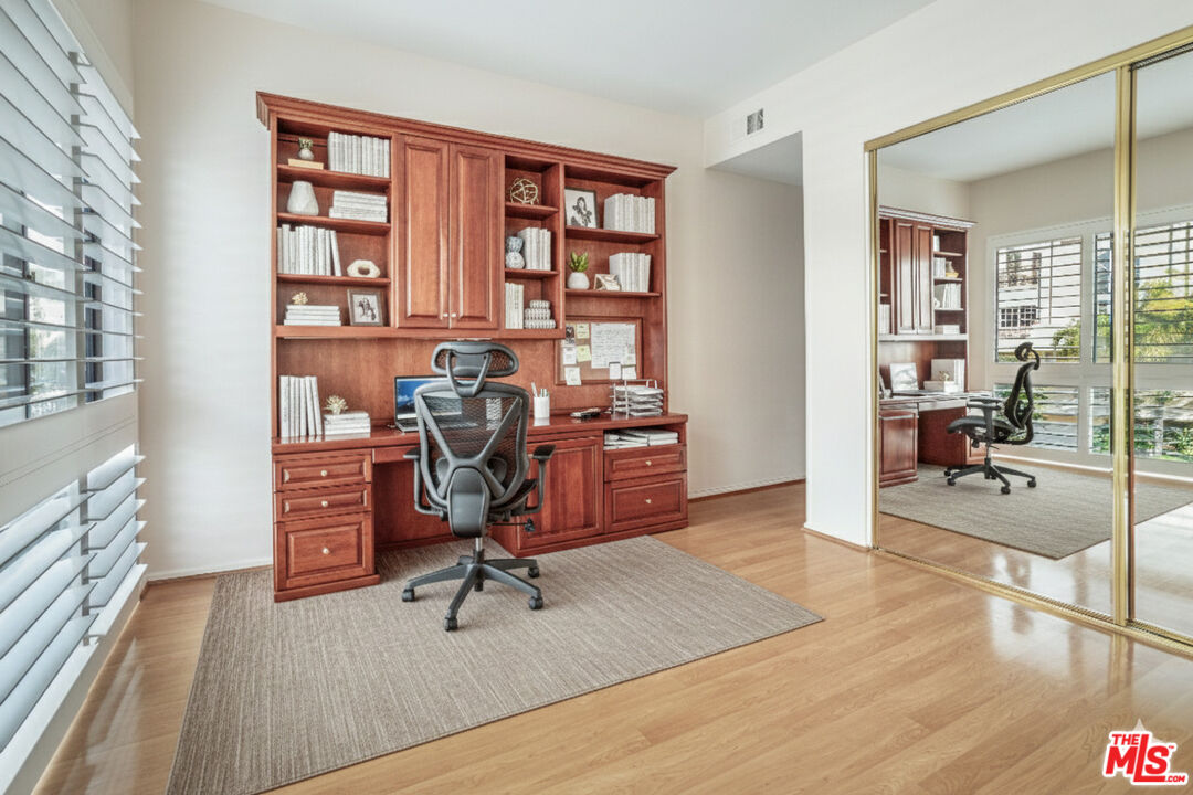 11808 Dorothy Street, Unit 206 Los Angeles, CA 90049 - Photo 25 of 33 a view of a workspace with furniture and wooden floor
