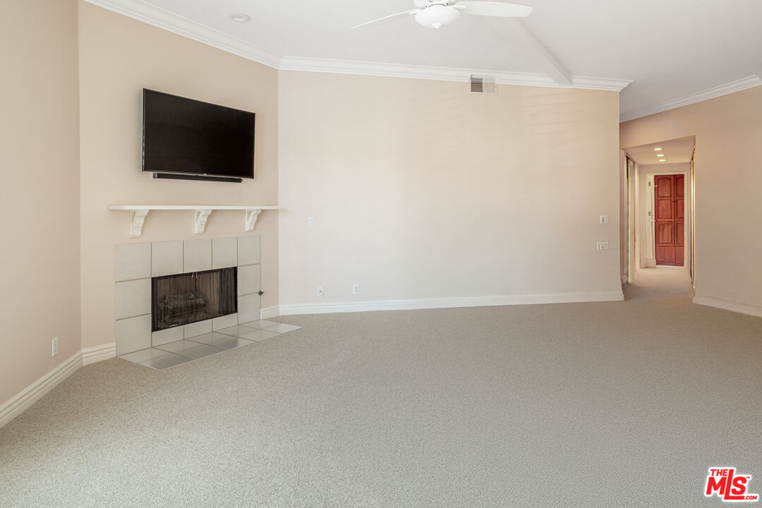11808 Dorothy Street, Unit 206 Los Angeles, CA 90049 - Photo 6 of 33 a view of a livingroom with a fireplace and a flat screen tv
