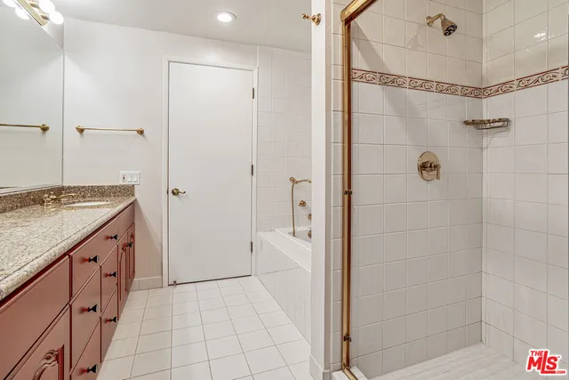 a bathroom with a granite countertop shower mirror and a sink