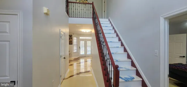 a bathroom with a sink and mirror with bathtub