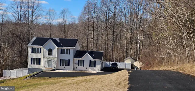a kitchen with stainless steel appliances kitchen island granite countertop a refrigerator and a stove top oven