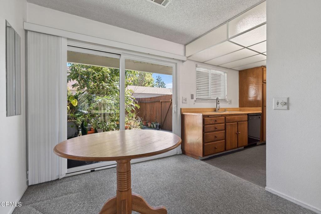 6508 Penn Street, Unit B Moorpark, CA 93021 - Photo 11 of 27 a kitchen with a stove a refrigerator and a table