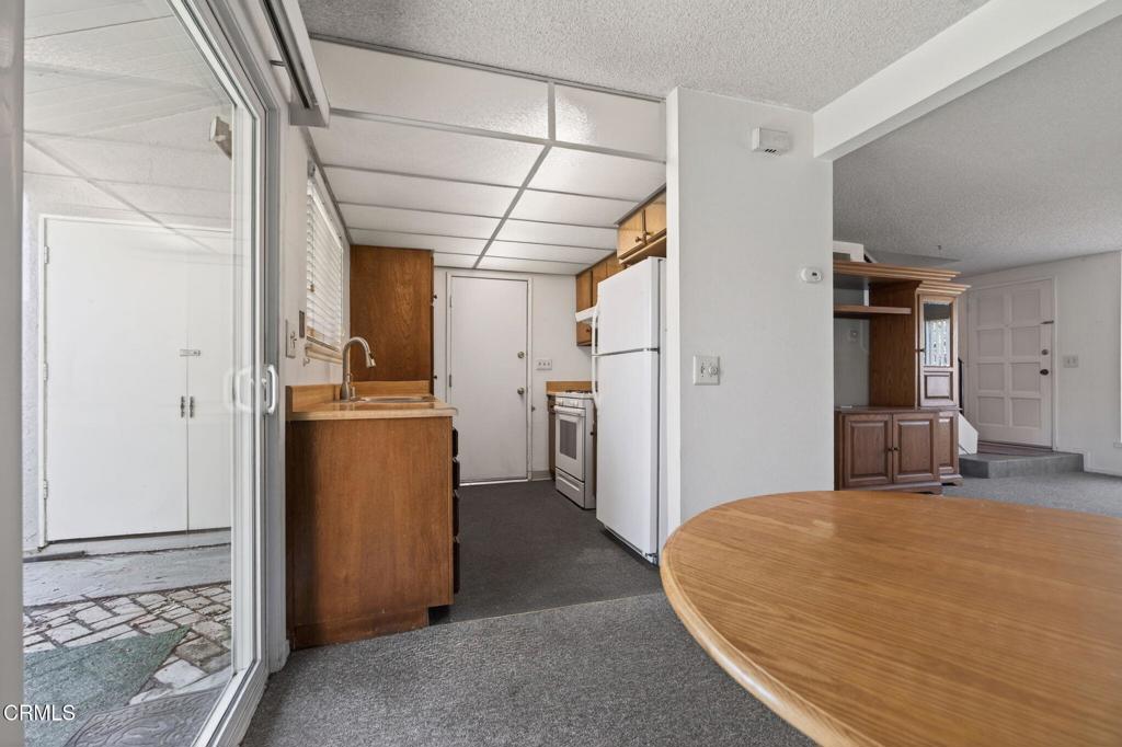 6508 Penn Street, Unit B Moorpark, CA 93021 - Photo 13 of 27 a bedroom with a bed and a refrigerator