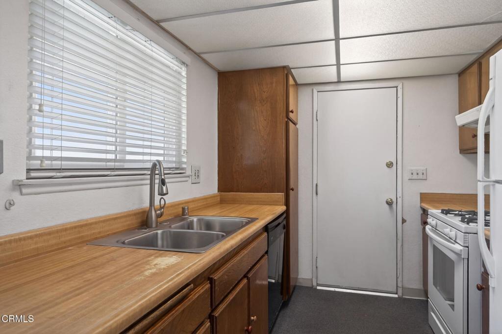 6508 Penn Street, Unit B Moorpark, CA 93021 - Photo 14 of 27 a kitchen with stainless steel appliances granite countertop a sink and a refrigerator
