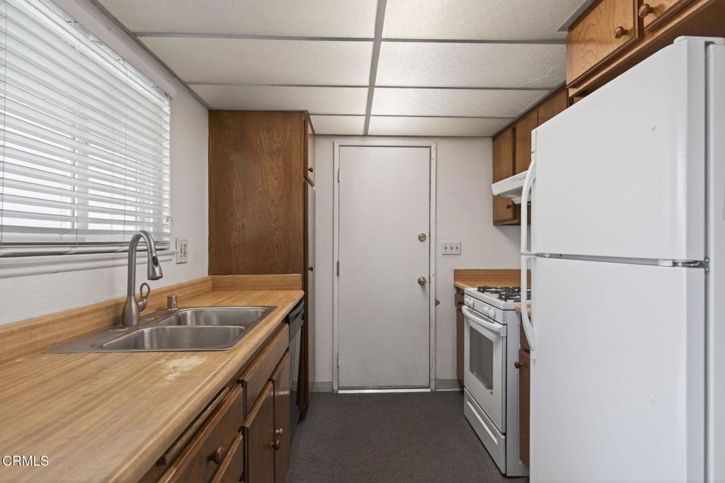 6508 Penn Street, Unit B Moorpark, CA 93021 - Photo 15 of 27 a kitchen with a refrigerator a sink and a stove