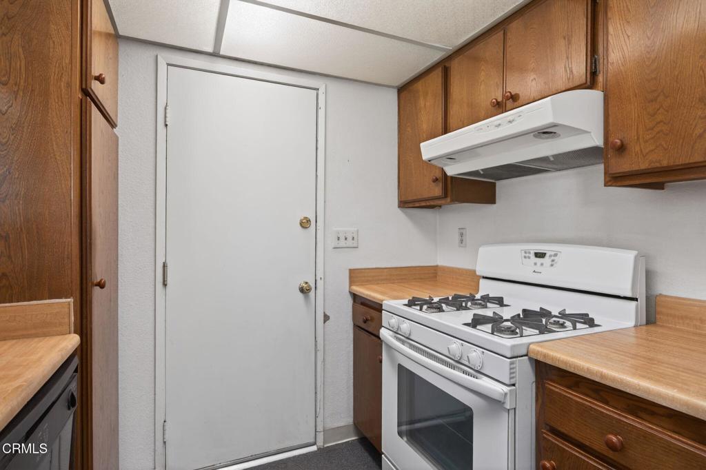6508 Penn Street, Unit B Moorpark, CA 93021 - Photo 16 of 27 a kitchen with stainless steel appliances granite countertop a stove and a refrigerator
