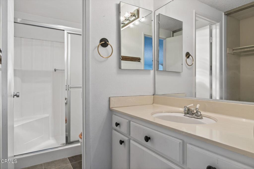 6508 Penn Street, Unit B Moorpark, CA 93021 - Photo 23 of 27 a bathroom with a granite countertop sink and a mirror