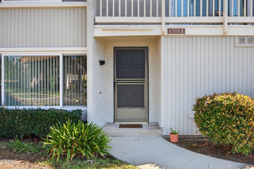 6508 Penn Street, Unit B Moorpark, CA 93021 - Photo 4 of 27 a potted plant sitting in front of a house with a garden