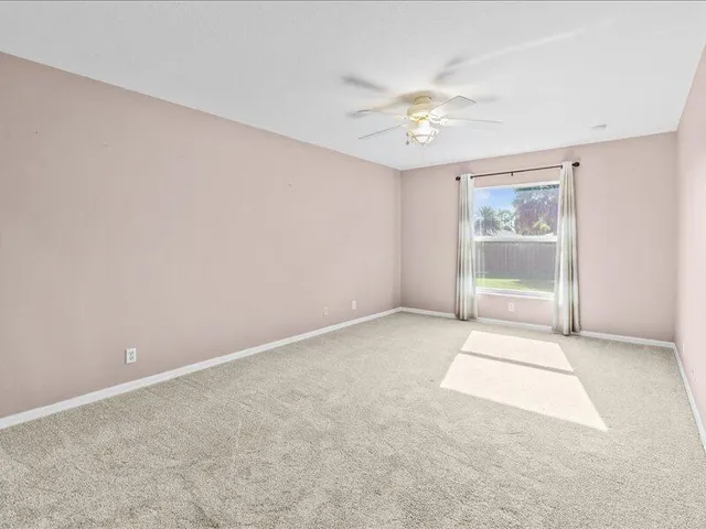 a bathroom with a tub shower and mirror