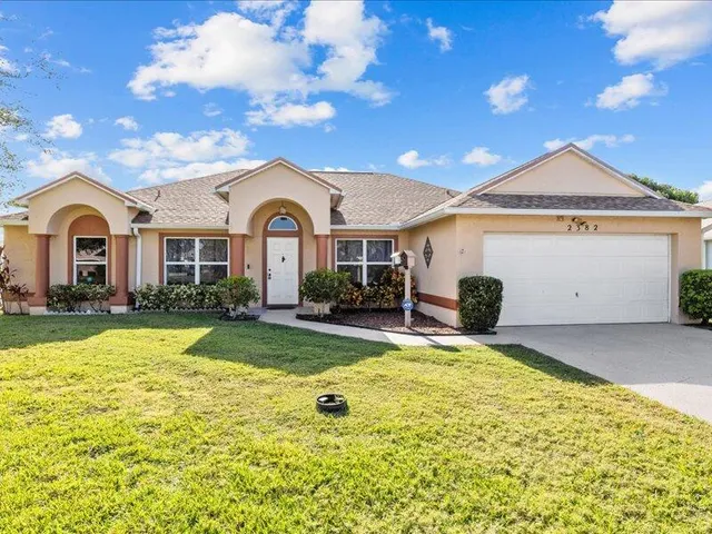 a front view of a house with swimming pool and porch with furniture