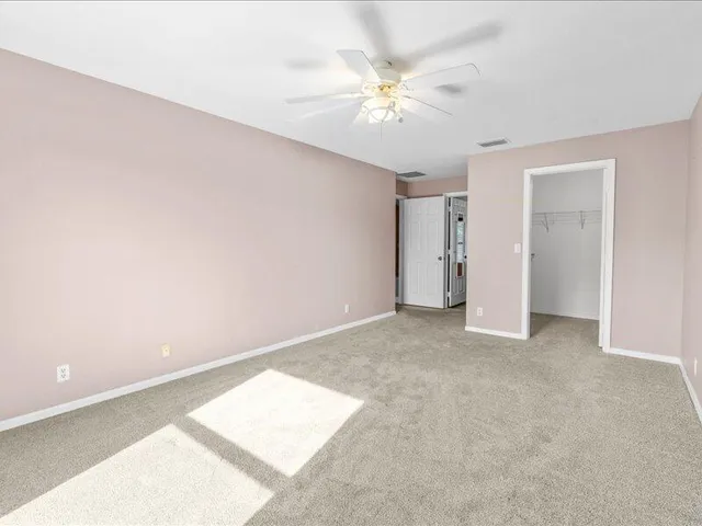 a spacious bathroom with a tub sink and mirror