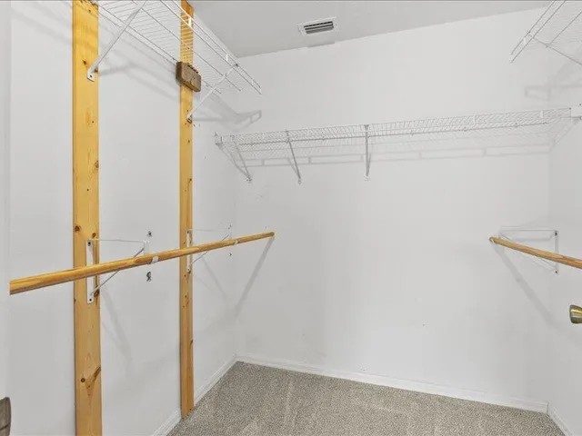 a spacious bathroom with a sink double vanity and a mirror