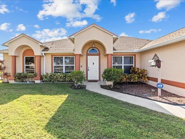 a front view of a house with garden
