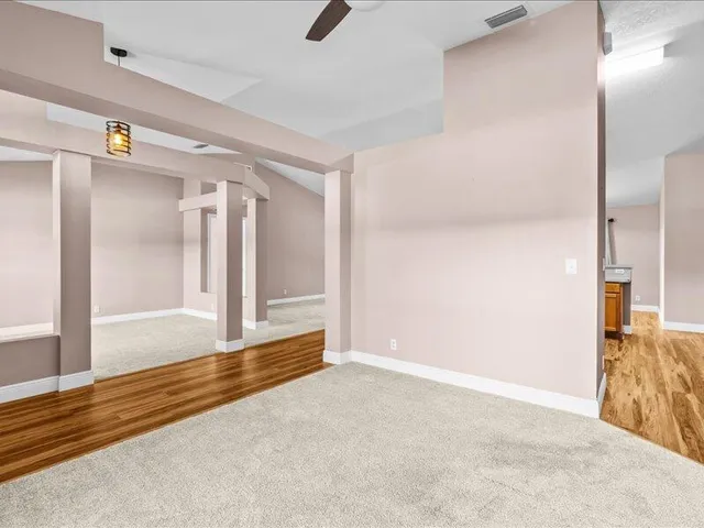 a view of a kitchen with a sink and a large window