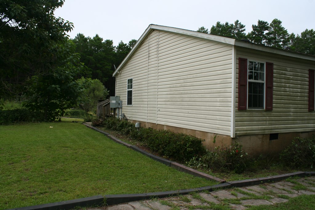 50 Simmons Road Mauk, GA 31058 - Photo 25 of 35 a view of a white house next to a yard