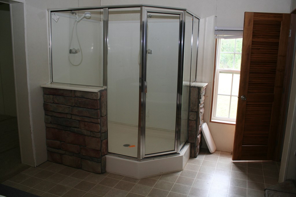 50 Simmons Road Mauk, GA 31058 - Photo 3 of 35 a view of a bathroom with a glass shower door