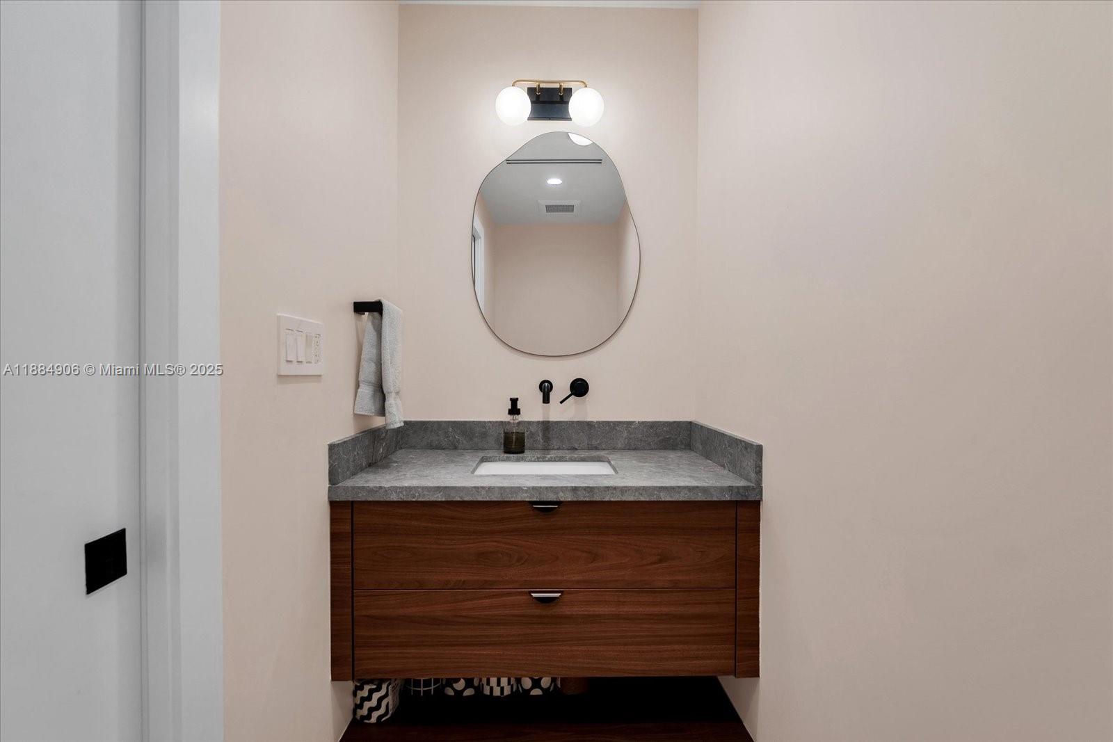 3111 Anderson Road Coral Gables, FL 33134 - Photo 13 of 34 a bathroom with a granite countertop sink and a mirror