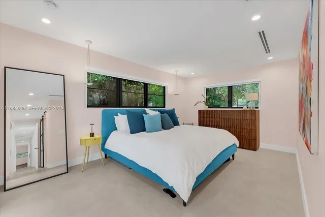 a bed room with a bed window and a dresser