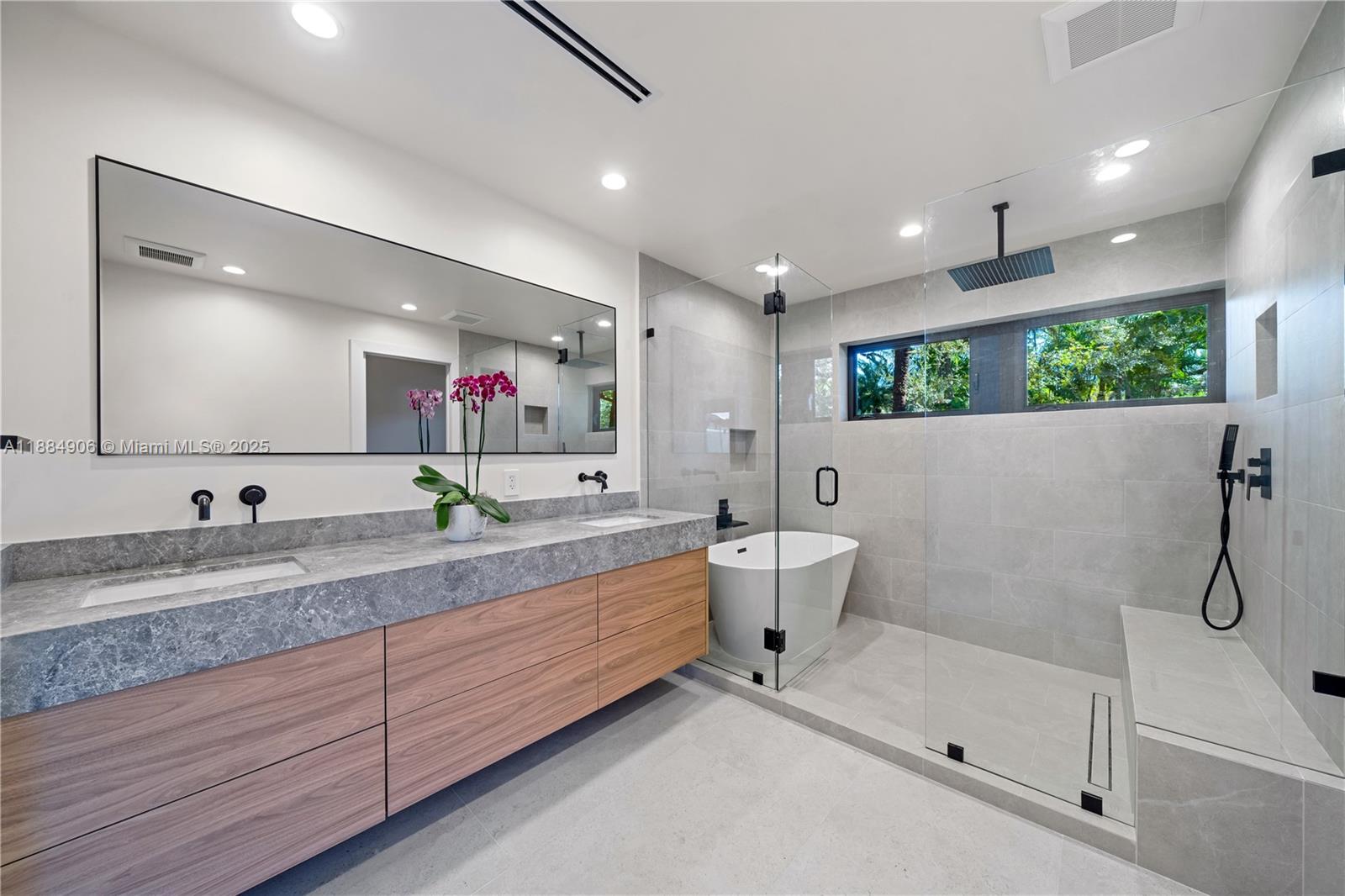 3111 Anderson Road Coral Gables, FL 33134 - Photo 20 of 34 a spacious bathroom with a granite countertop sink mirror and bathtub