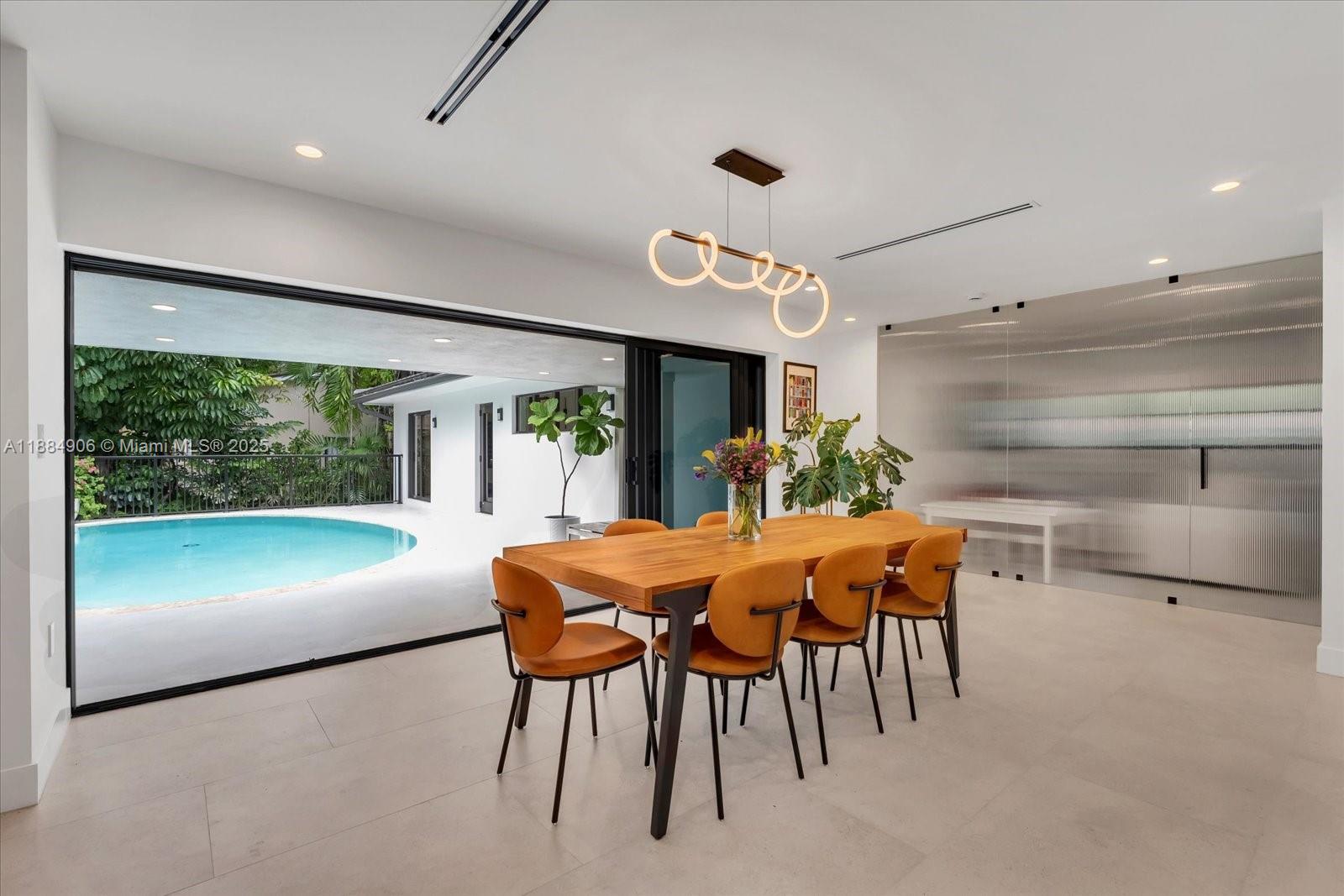 3111 Anderson Road Coral Gables, FL 33134 - Photo 25 of 34 a dining room with furniture and a floor to ceiling window