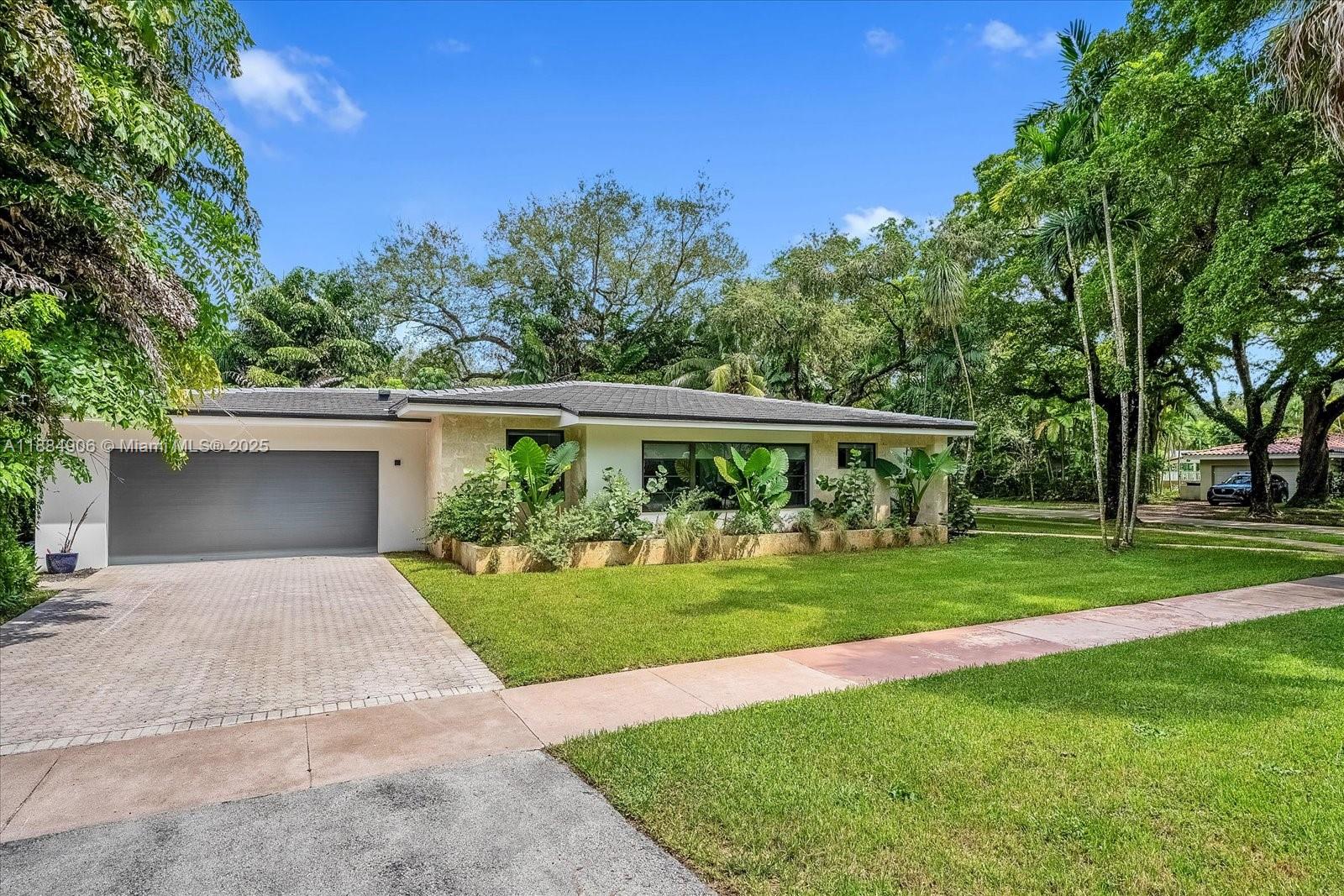 3111 Anderson Road Coral Gables, FL 33134 - Photo 29 of 34 a front view of a house with a yard