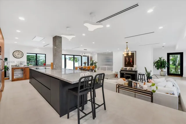 a kitchen with stainless steel appliances kitchen island granite countertop a sink and a stove