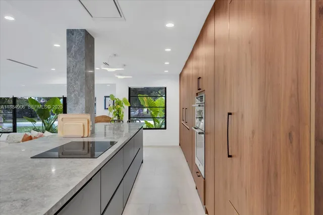 an open kitchen with a sink and large window