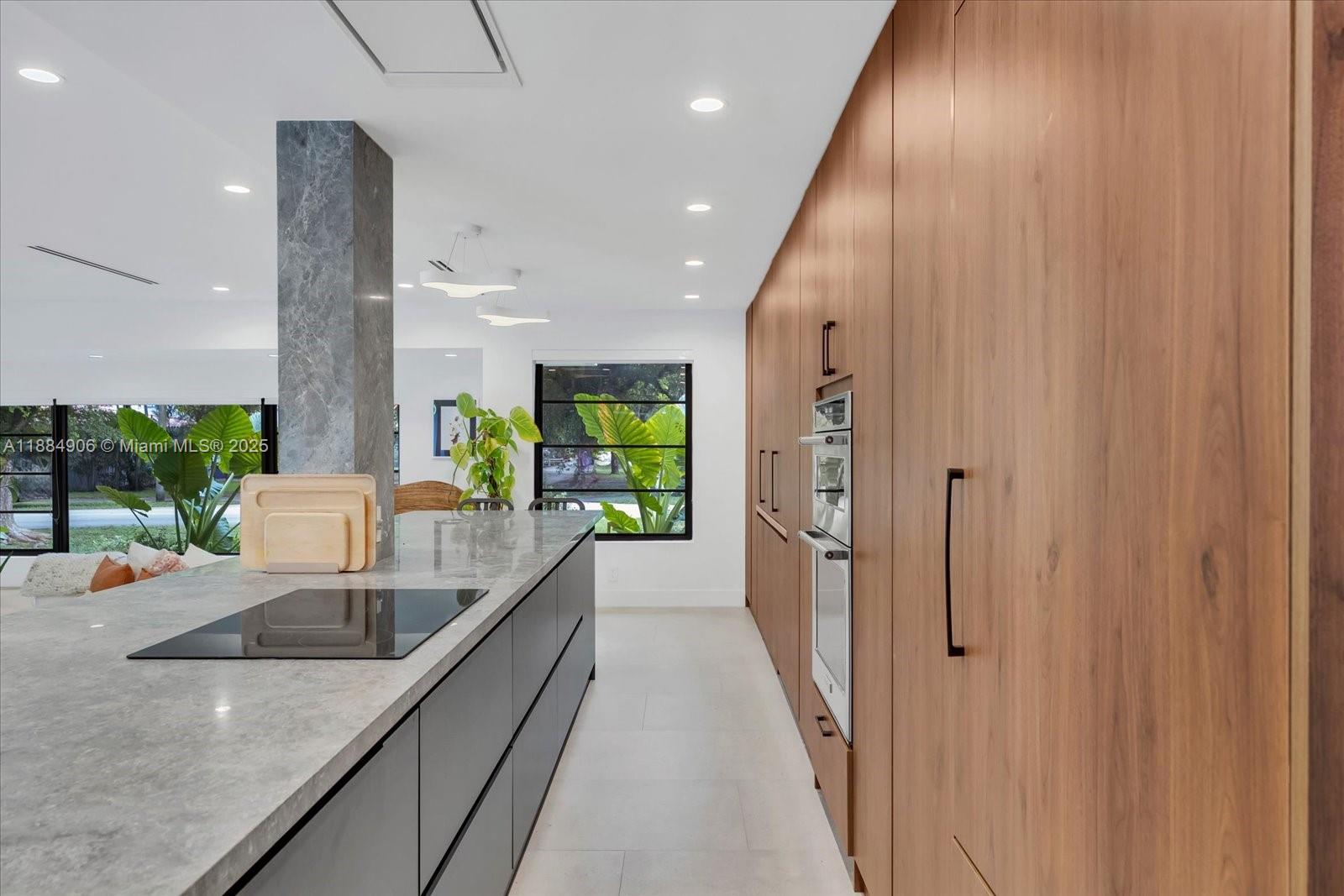 3111 Anderson Road Coral Gables, FL 33134 - Photo 7 of 34 an open kitchen with a sink and large window