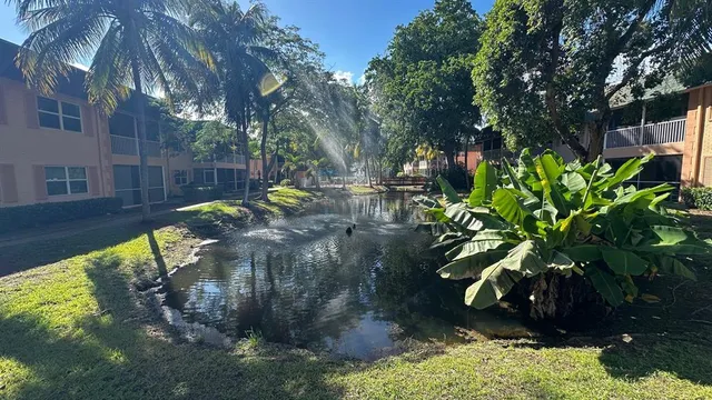 a view of a backyard with swimming pool