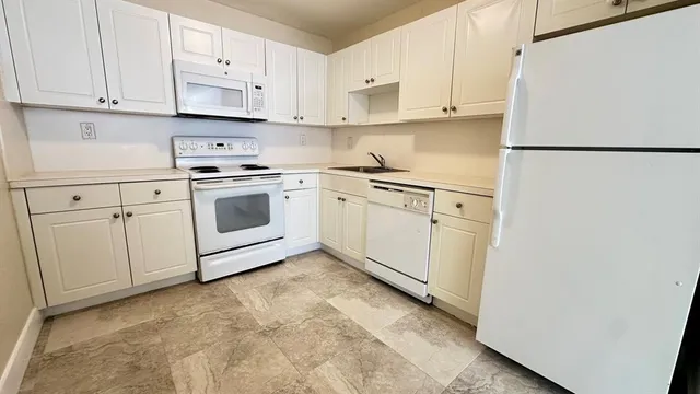 a view of a kitchen with refrigerator and cabinet