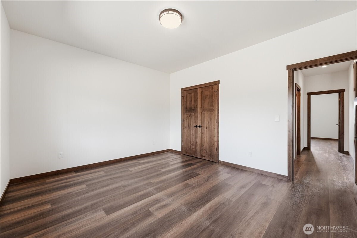 110 Slide View Lane Manson, WA 98831 - Photo 30 of 38 a view of an empty room with wooden floor and a window