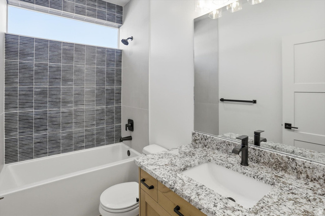 1315 West 3200 South, Unit 17 Perry, UT 84302 - Photo 19 of 58 Bathroom featuring a light wood-finish vanity with a granite countertop and undermount sink