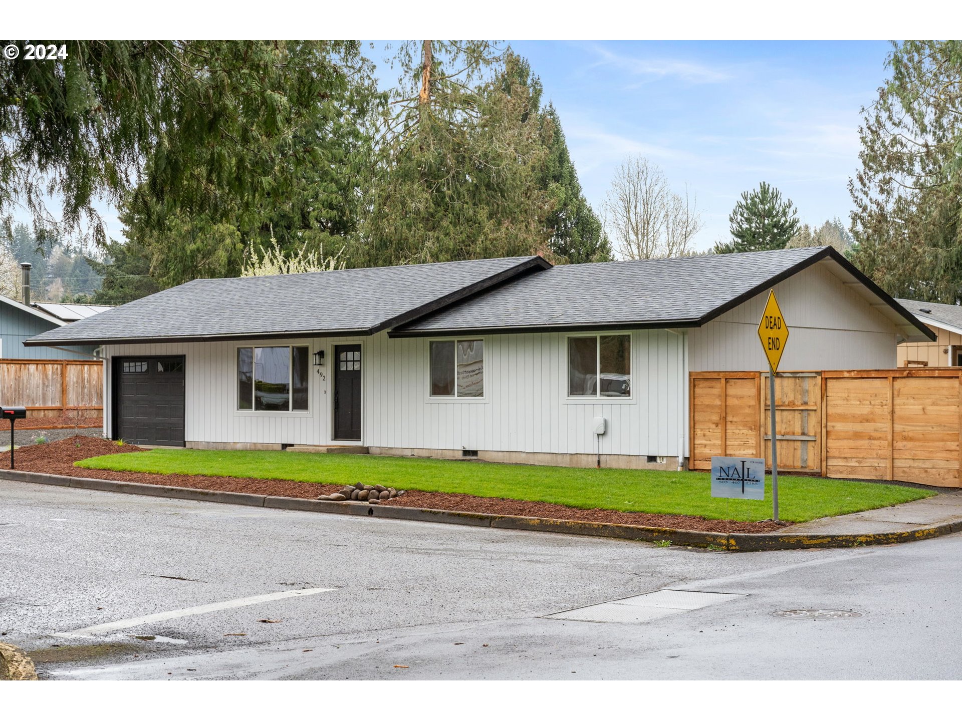 492 Southwest Grove Road Estacada, OR 97023 - Photo 3 of 36 a front view of a house with a yard and garage