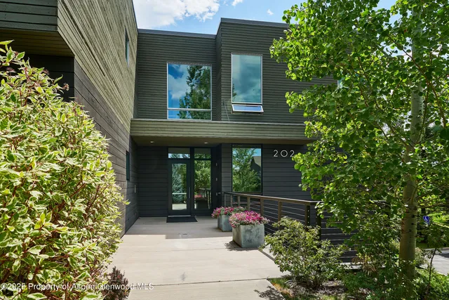 a view of a house with a sitting area and garden