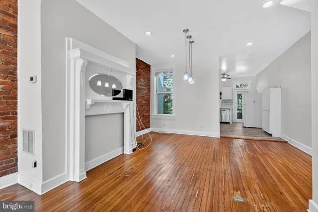 a view of a kitchen with wooden floor and a sink