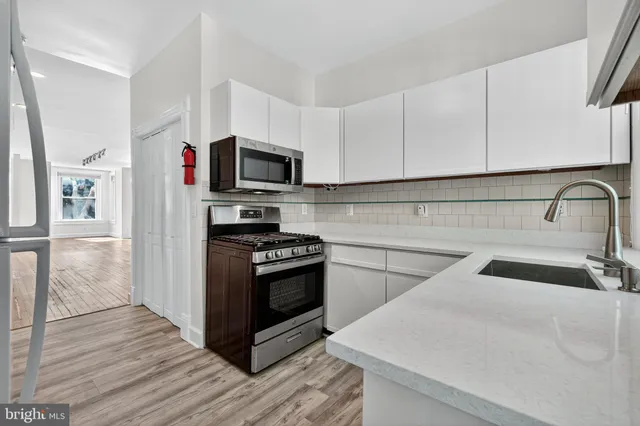 a kitchen with sink a microwave and stove