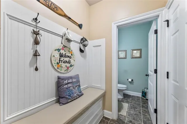 a kitchen with stainless steel appliances granite countertop a sink a stove a microwave a refrigerator cabinets and chairs