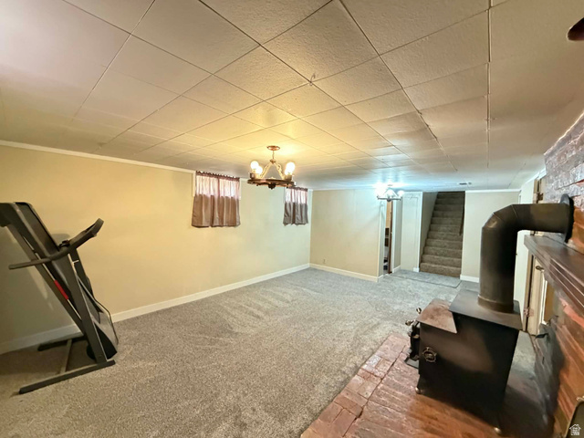 156 D Street Helper, UT 84526 - Photo 18 of 24 Finished basement with a wood stove and carpet floors