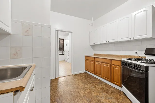 a kitchen with a sink stove and cabinets