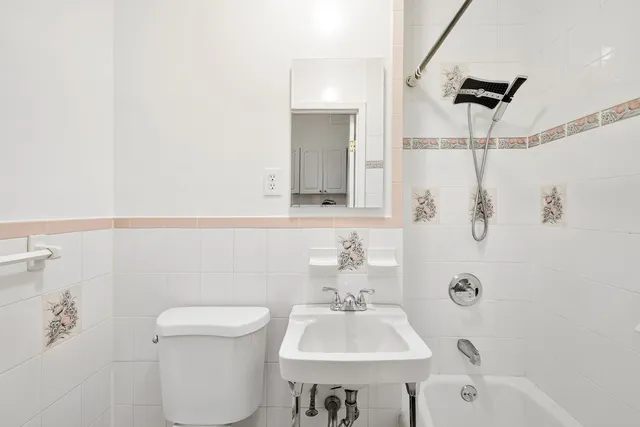 a bathroom with a sink mirror and toilet